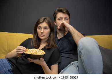 Couple Watching Tv Movie Hugging Lying On Couch Eating Popcorn Home. Girlfriend And Boyfriend Watch Love Story, Investigation, Thriller On YouTube Channel Online Broadcast. Young Family Entertainment