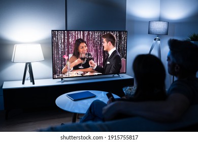 Couple Watching TV Movie On Couch At Night