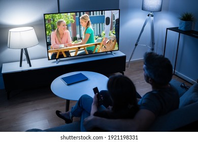 Couple Watching TV Movie On Couch At Night