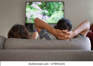 A Couple Watching Tv And Relaxing At Home.