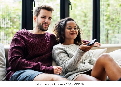 Couple watching a tv show together - Shutterstock ID 1065533132