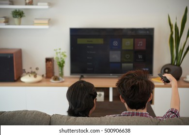 Couple Watching Tv Shows On Their Smart Tv At Home