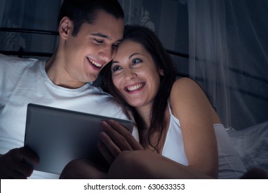 Couple Watching A Video On Their Tablet Computer