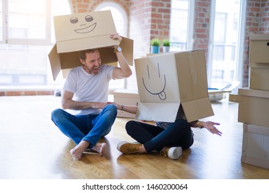 Couple wearing funny cardboard boxes with happy faces, moving to - Shutterstock ID 1460200064
