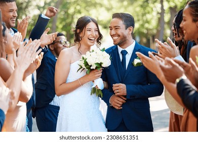 Couple, wedding and guests clapping hands in celebration of love, romance and union. Happy, smile and young bride with a bouquet and groom walking by crowd cheering for marriage at an outdoor event. - Powered by Shutterstock