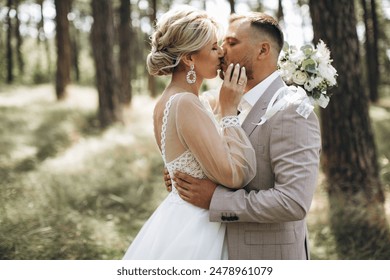 Couple, wedding and kissing with vail for love, compassion or affection together in nature. Married man kiss woman on lips, hugging in marriage, relationship or loving embrace for commitment outdoors - Powered by Shutterstock