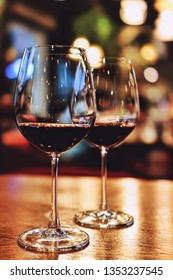 A Couple Of Wine Glass On A Dating Table Under The Candle Light In A Warm Night, Background Is A Bokeh, Dinner Date Night For Valentine Day, Romantic Scene Concept For Celebrate A Special Day,