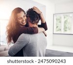 Couple, woman hug and laughing in home kitchen with love, bonding and smile together with joy. Embrace, romance and happy people with marriage with care, trust and commitment in house with fun joke