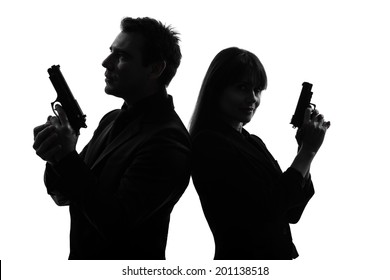 couple woman man detective secret agent criminal with gun in silhouette studio isolated on white background