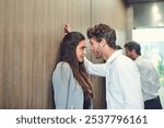 Couple, woman and man in elevator, romance and affection for forbidden love, talking and joy of lover. Secret, bonding and corporate people with smile, colleagues and hiding relationship in lift