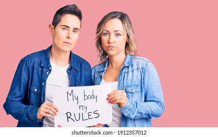 Couple Of Women Holding My Body My Rules Banner Thinking Attitude And Sober Expression Looking Self Confident 
