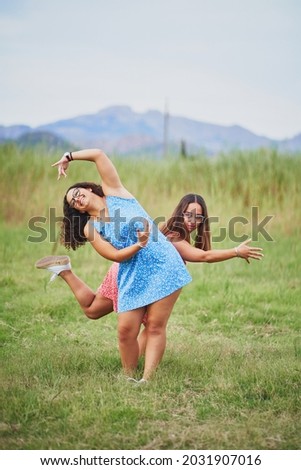 Similar – Happy women jumping in front of garden fence