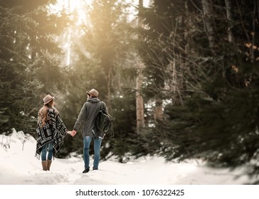 Couple In The Woods Walking Holding Hands