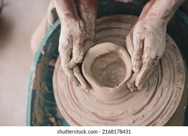 Couple work on potter's wheel, doing vase. Hands of woman and man sculpt pot from white clay. Workshop for manufacturing potter's products. handmade and love, artist - Powered by Shutterstock