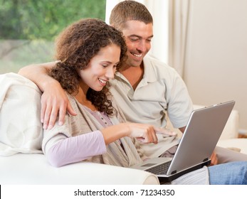 Couple working on their laptop at home