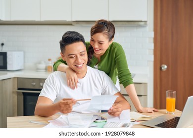 Couple working out finances at home - Powered by Shutterstock