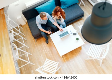 Couple Working Together In Beautiful Living Room With Laptop On Desk