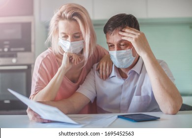 Couple worried about paperwork discuss unpaid bank debt calculate bills, shocked poor family looking at calculator counting loan payment upset about money problem during the pandemic coronavirus