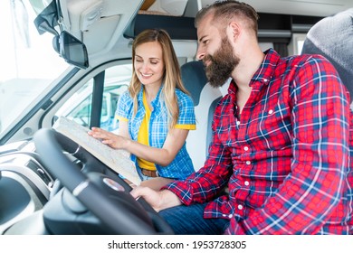 Couple At Yard Of RV Dealer Planning The Trip With Their Camper