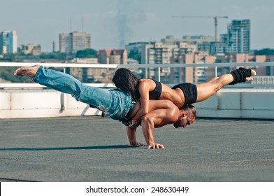 Couple yoga of woman and man on the house-top - Powered by Shutterstock