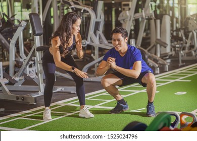 Couple young diversity working out in gym fitness sport complex, doing squad and cardio, posture position, Push up on weights, sports and healthcare,asian and asean people, concept - Shutterstock ID 1525024796