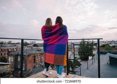 Couple young girls staying on city background. Spending good time together on roof, unusual places for rest and entertainment, open space leisure and best friends forever concept. Free space