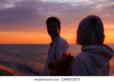 Couple of young lovers girlfriend and boyfriend walking on beach at sunset, follow me. - Shutterstock ID 2348072873