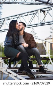 Couple Of Young Man And Woman In Love Having Fun Together At Steel Construction At Romantic Dating, Sensual Relationship And Desire Of Lovers, Candid Lifestyle, Vertical Image With Industrial Style