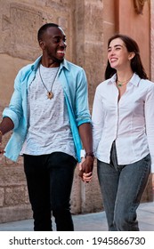 Couple Of Young Multiethnic Guys Laughing As They Walk Through The Streets Of The City, Black Guy And White Girl In Love