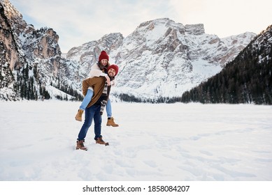 Couple Of Young People On Winter Vacation Having Fun On The Background Of Alpine Mountains.