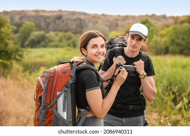 Couple of young tourists in countryside - Powered by Shutterstock