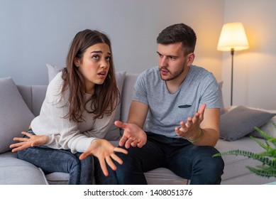 Couples Are Angry With Love Issues. Not Understanding Each Other In Family Problems Or Infidelity . Couple Having Argument On The Couch At Home In The Living Room