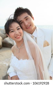 couples of asian man and woman in white wedding suit
