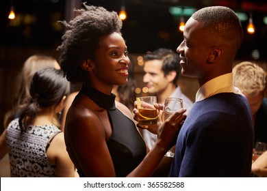 Couples Dancing And Drinking At Evening Party
