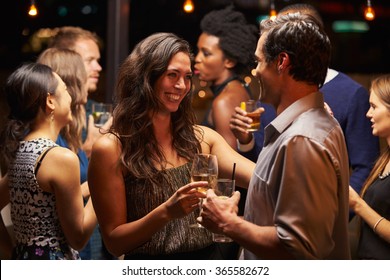 Couples Dancing And Drinking At Evening Party