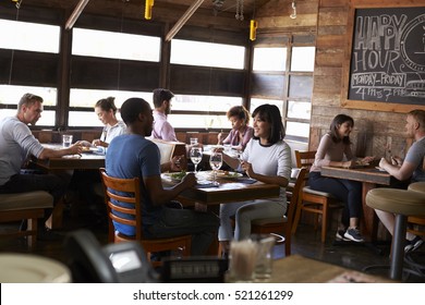 Couples Enjoying Lunch In A Busy Restaurant