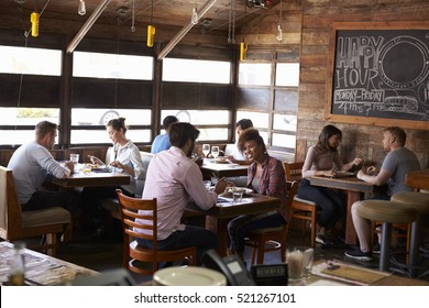 Couples Enjoying Lunch At A Busy Restaurant