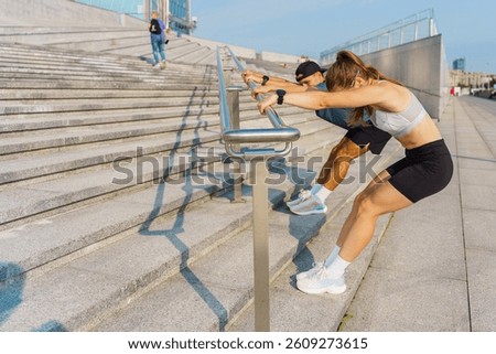 Couples Exercise Together Using Urban Railings for Bodyweight Workouts Along a Sunlit Waterfront Promenade