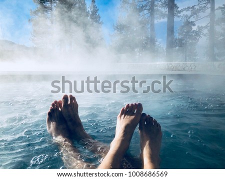 Couples Feet in Hot Tub Jacuzzi Spa Outdoors with Mist Romantic Getaway
