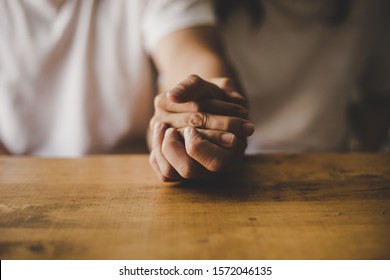 Couples hold hands praying for blessings from God.low key tone - Shutterstock ID 1572046135