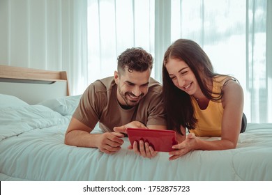 Couples lovely have just started a family listen to music and using tablet while in the bedroom. They are happy and create good relationships in the future with relax and live a new normal life. - Shutterstock ID 1752875723