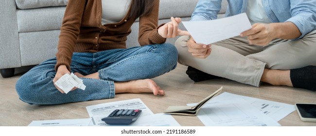 Couples Managing Debt And Expenses. People Holding Credit Card Invoices And Electricity Bills In The House.  Broke, Mortgage, Loan, Bankruptcy, No Money, Bankrupt, Can't To Pay 