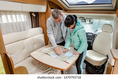 Couples in RV Camper looking at the local map for the trip. Family vacation travel, holiday trip in motorhome, Caravan car Vacation. - Powered by Shutterstock