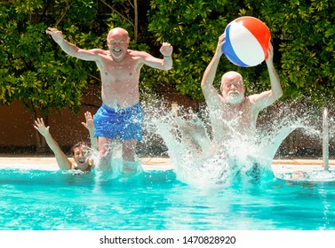 Couples of senior people playing in the blue and transparent water of the swimming pool. Man jumps into the pool with a large inflatable ball - Powered by Shutterstock