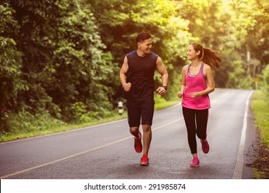 Couples take vacations jogging in the forest. The integrity and refreshing - Powered by Shutterstock