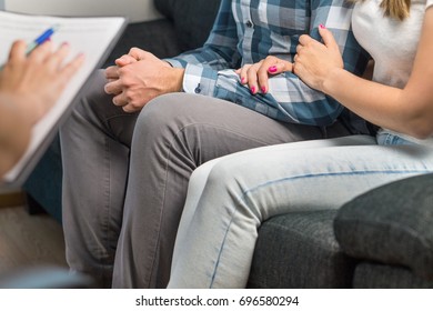 Couples Therapy Or Marriage Counseling. Woman Hugging Man's Hand On Couch During A Psychotherapy Session. Psychologist, Counselor, Therapist, Psychiatrist Or Relationship Consultant Giving Advice. 