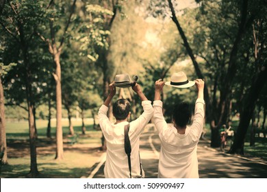 Couples throw his hat in the sky