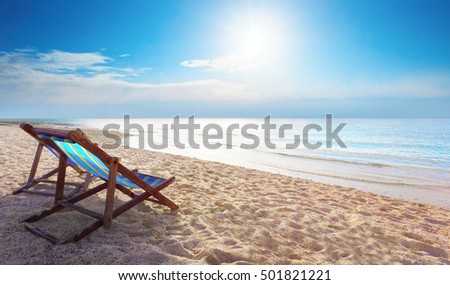 couples of wood chair beach and blue sky at sea side for summer vacation 