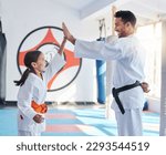 Courage conquers all. Shot of a young man and cute little girl practicing karate in a studio.