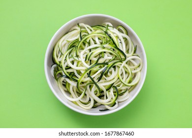 Courgette Noodles In Bowl On Green Background